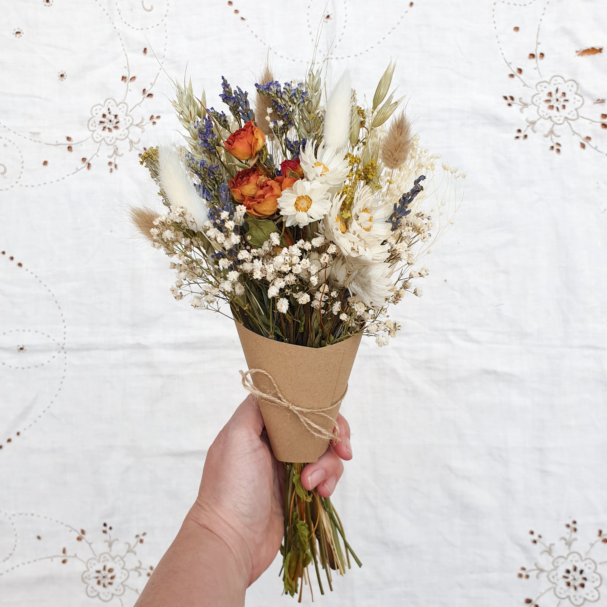 The mini size of the bouquet is shown held in the hand, it is a cute and petite size of posy, suitable for small bottles and bud vases.